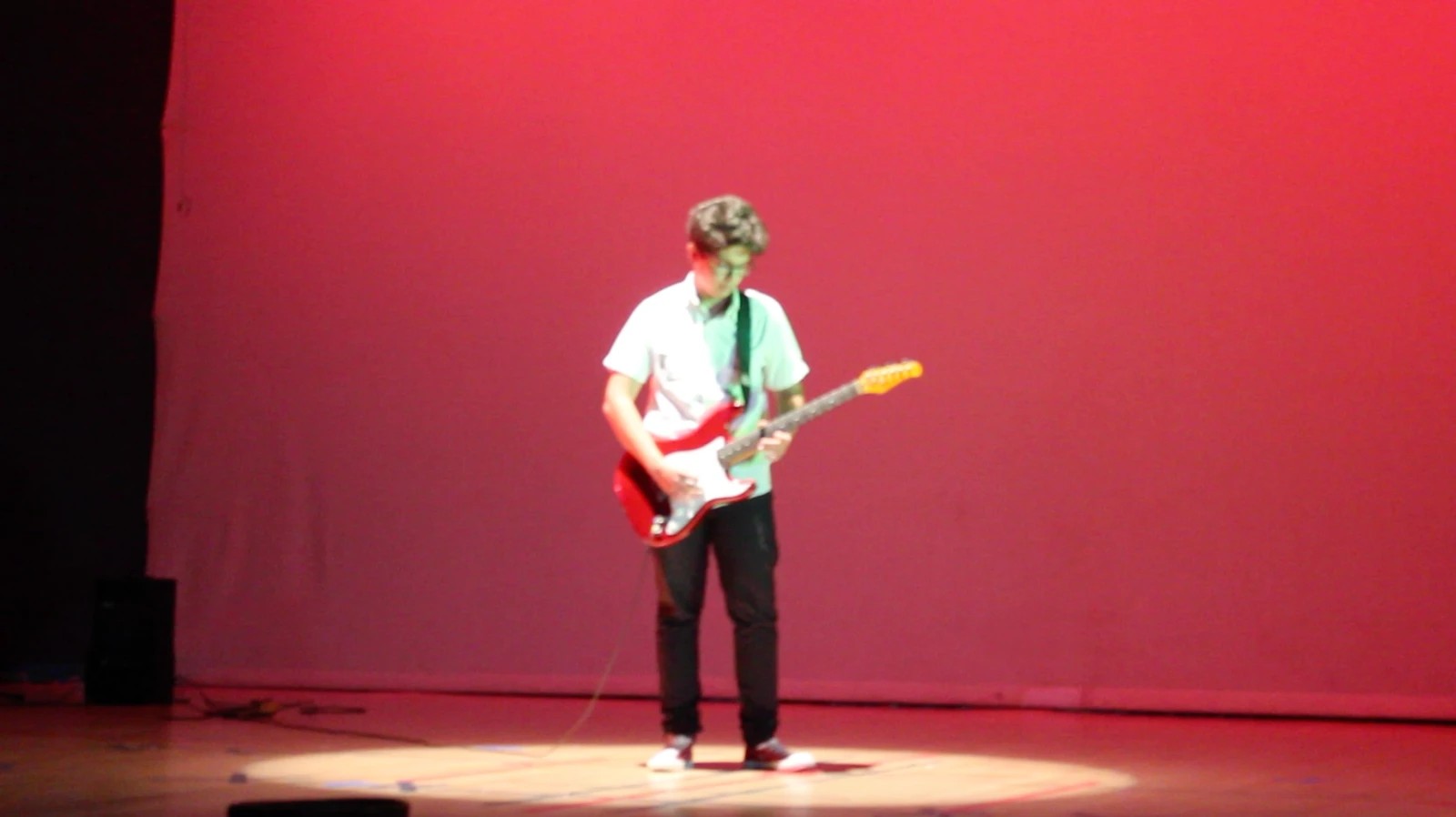 Nizar Masadeh performing guitar at the Jubilee School graduation ceremony